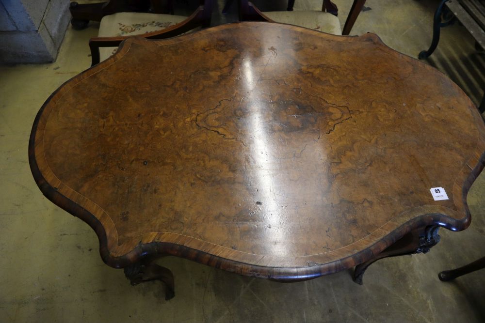 A Victorian figured walnut centre table of serpentine form, with ormolu mounted cabriole legs, width 130cm, depth 89cm, height 74cm